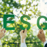 Hands of business team holding ESG text, Environmental, social a
