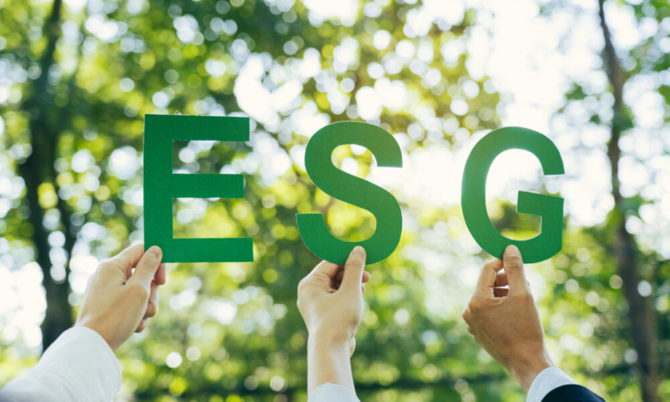 Hands of business team holding ESG text, Environmental, social and corporate governance concept.