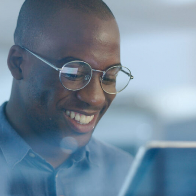 Networking, smile and black man in office on tablet for web design ideas, online project and websit.