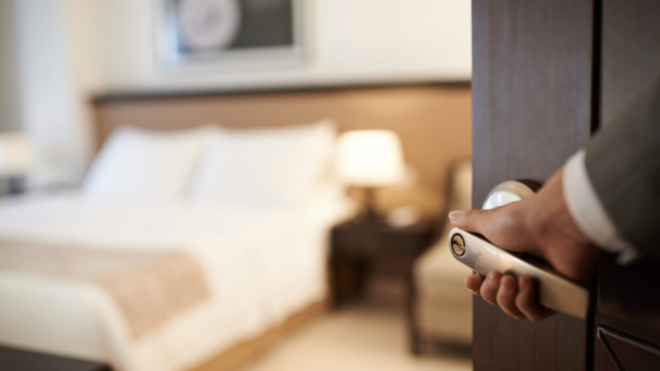 Hotel staff opening a guest room door, symbolising how NetSuite Consulting Partners help the hospitality industry deliver seamless guest experiences.