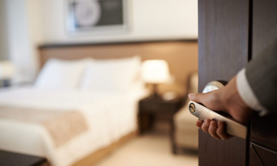 Hotel staff opening a guest room door, symbolising how NetSuite Consulting Partners help the hospitality industry deliver seamless guest experiences.