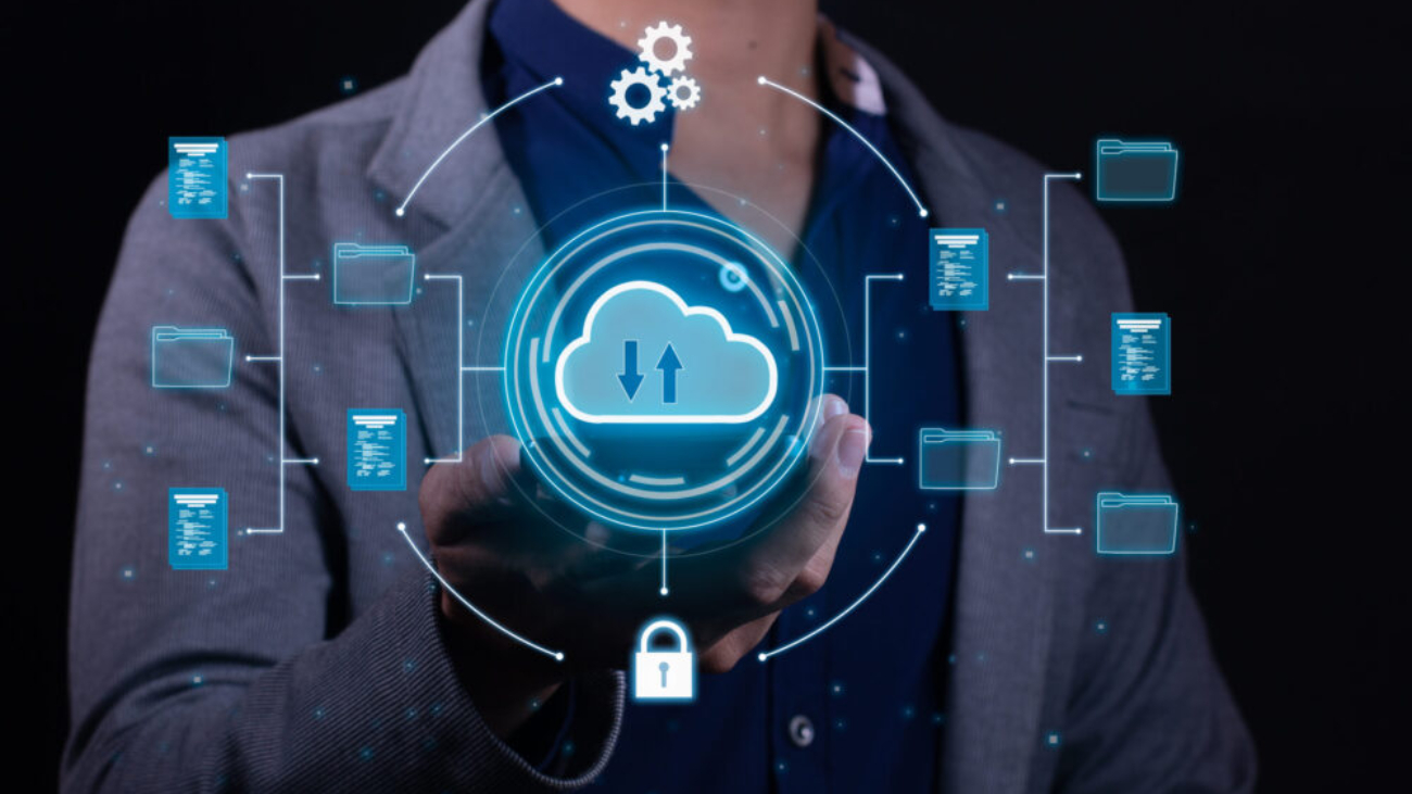 Business professional holding a glowing cloud computing icon with connected file folders and security symbols, representing a move from Xero to NetSuite cloud ERP.