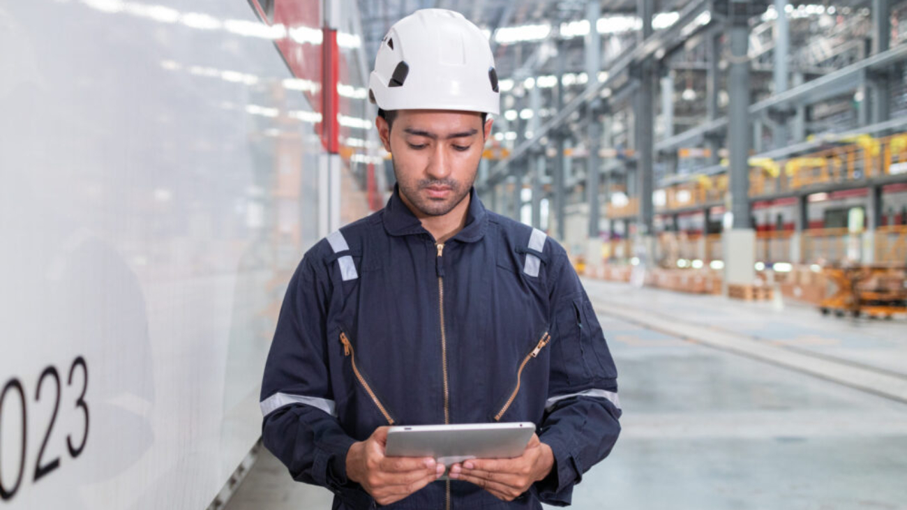 Man with tablet checking manufacturing floor