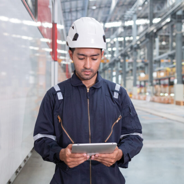 Man with tablet checking manufacturing floor