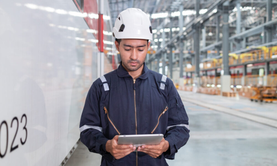 Man with tablet checking manufacturing floor