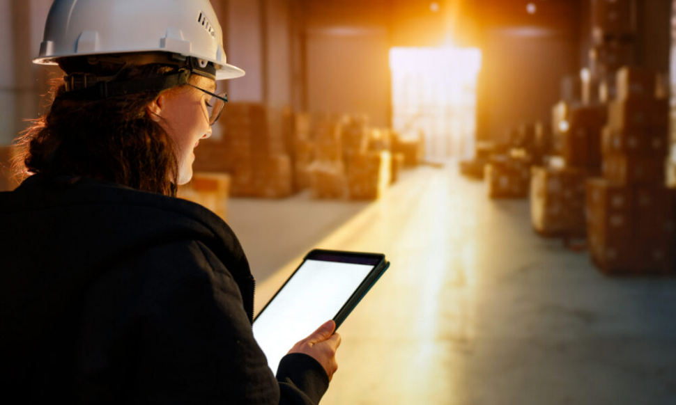Young woman working in a warehouse using NetSuite to manage inventory and operations