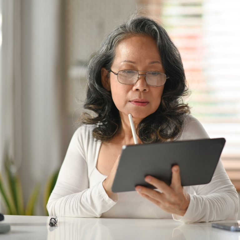 Finance manager reviewing real-time financial dashboards on a tablet, representing a NetSuite ERP finance system